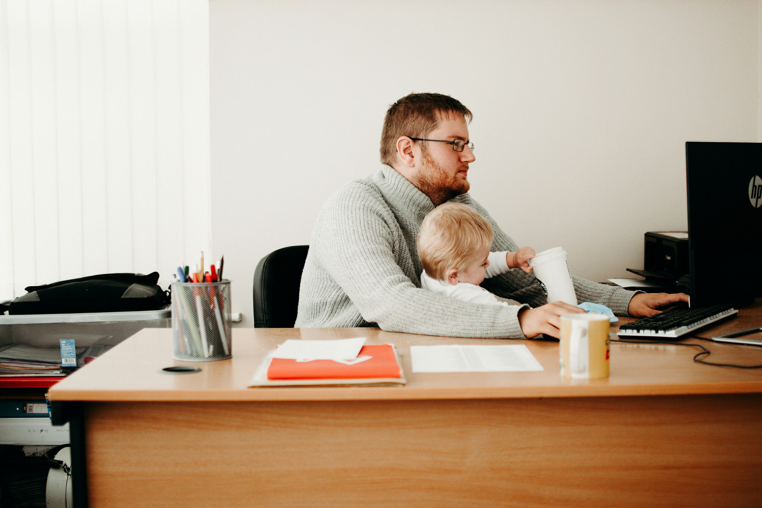 Father on a computer with his son in his lap