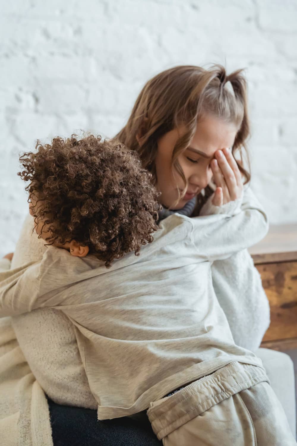 Child in arms of stressed out mom