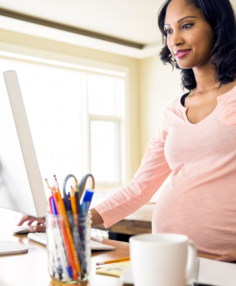 pregnant woman at a work computer