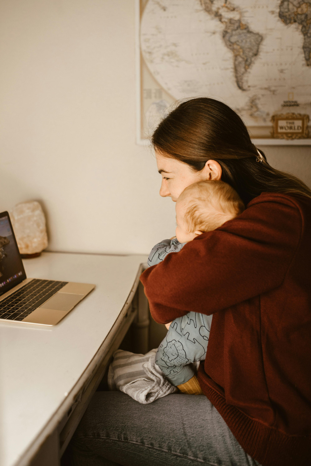 woman with baby on laptop