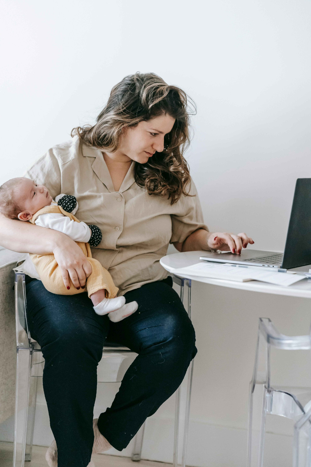 woman with baby on laptop